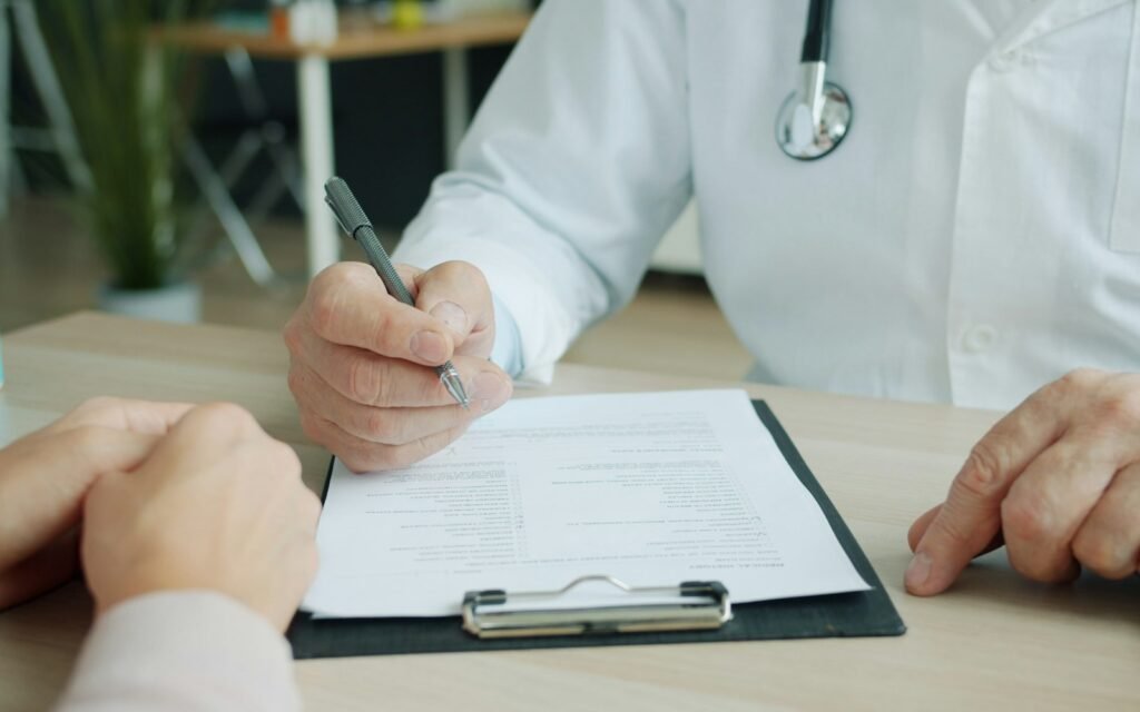 Physician making notes in a patient file